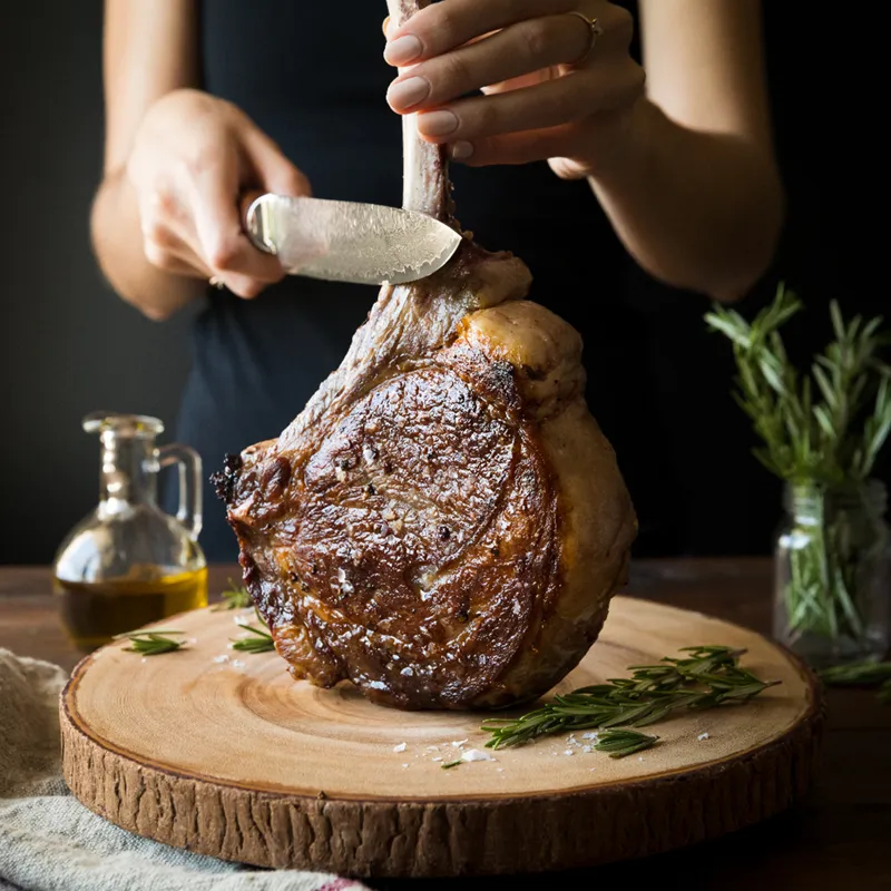 Holy Grail Steak Co. — cutting tomahawk steak
